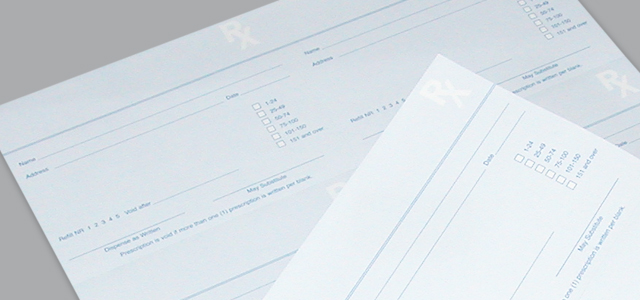 Two checkbooks on a gray surface